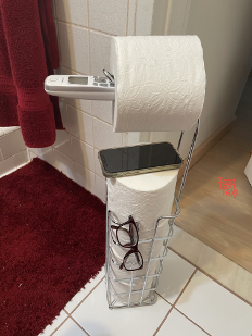 Rolls of toilet paper and cellphone